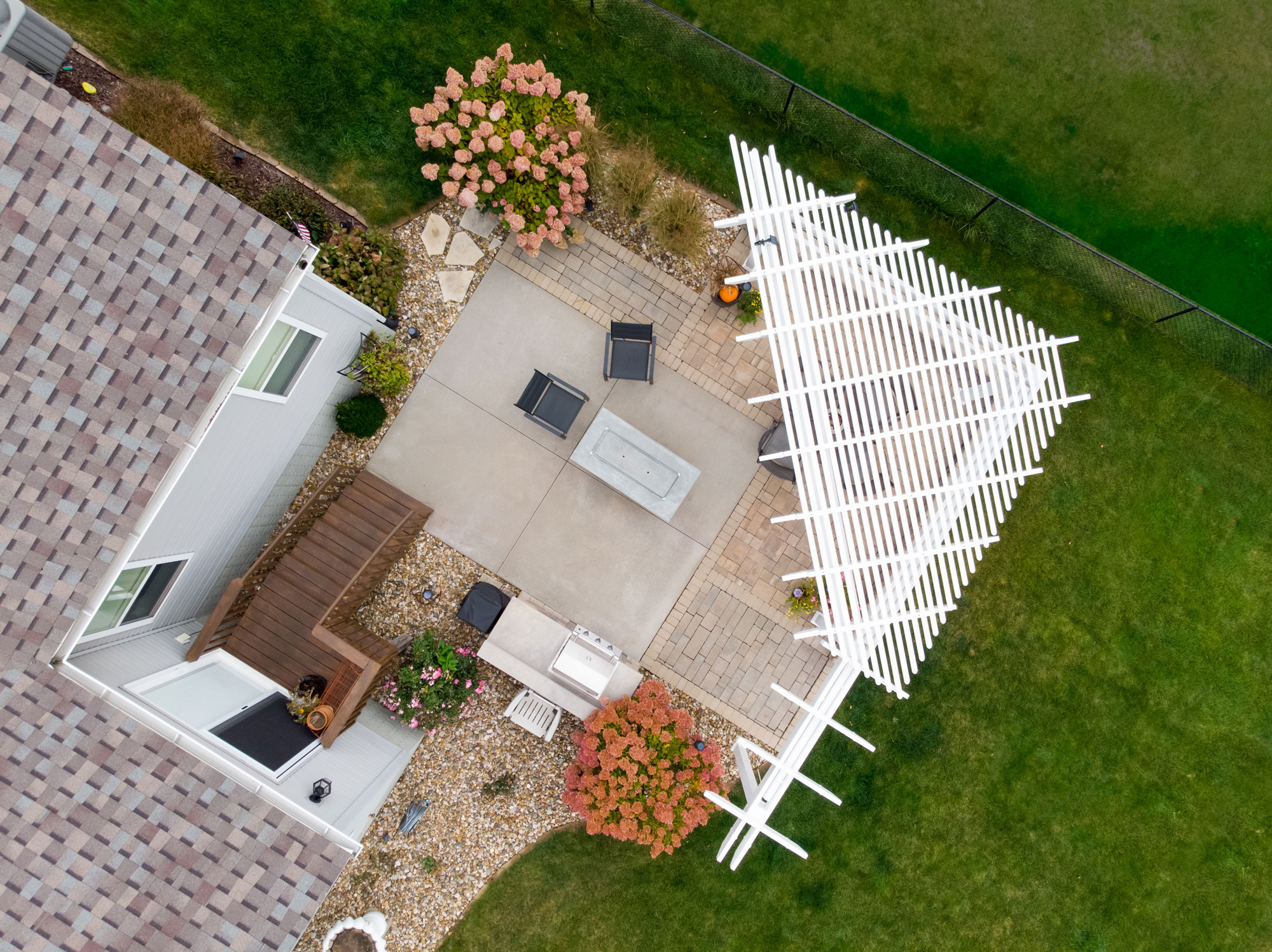 Triangle or corner pergola on an outdoor hardscape patio with arbor