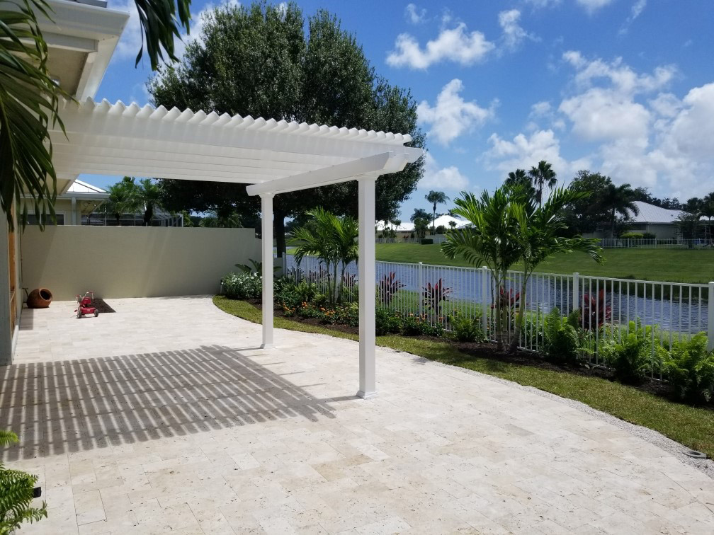 A pergola casts shade on the patio below at a Florida backyard