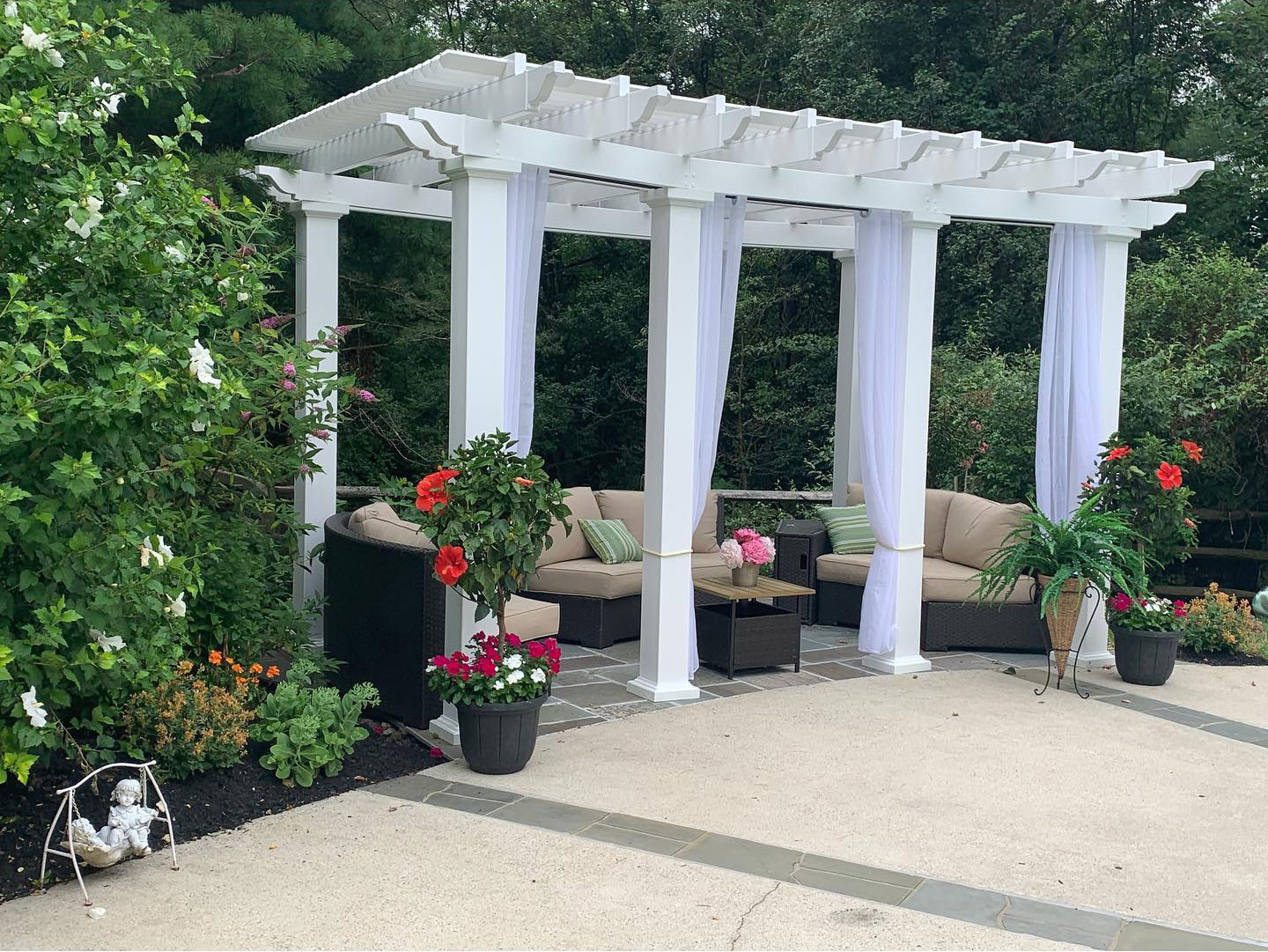 White poolside pergola with curtains and loungers