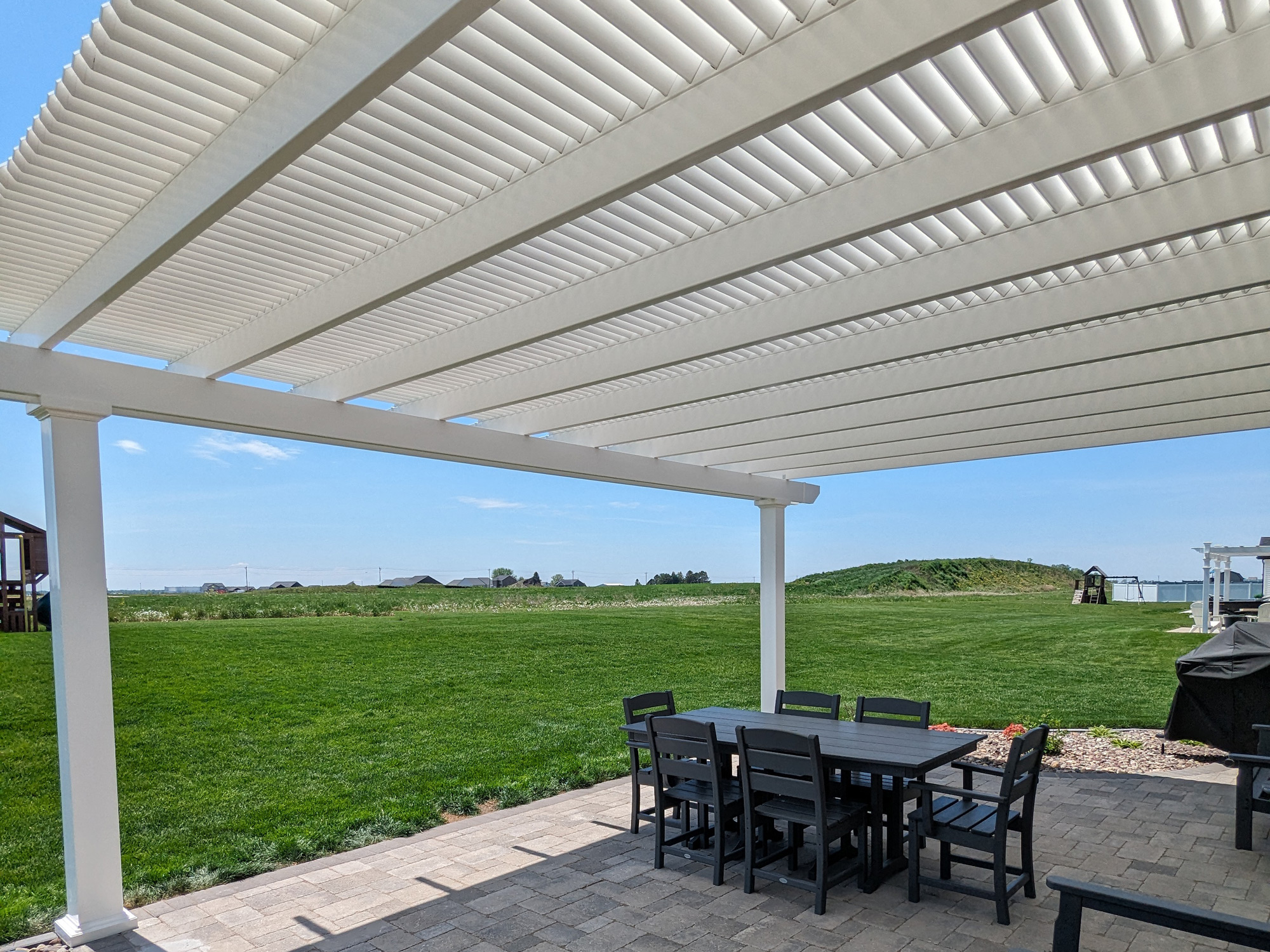 White pergola with louveres to provide shade