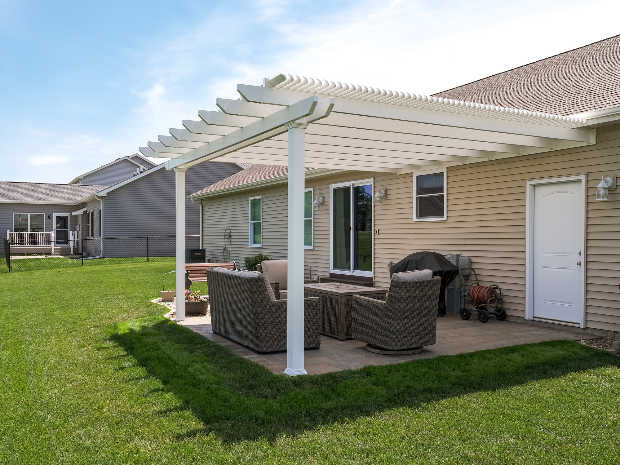 pergola with 90% shade blocks out almost all direct overhead sun on a patio with dining table