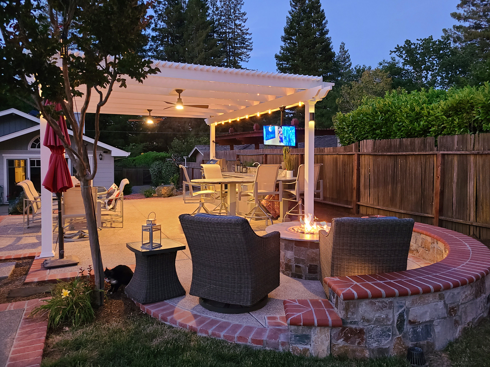 pergola with tv mounted to the pergola beam showing a football game