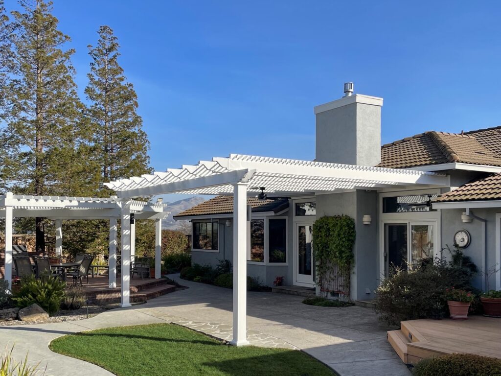 Custom tall pergola attached to California home with mountains in the distance