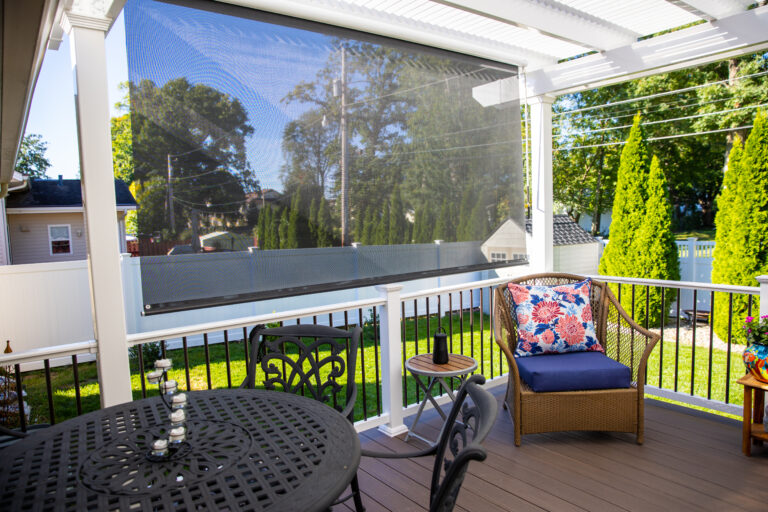 Pergola on a deck with pull down sun screen for additional shade