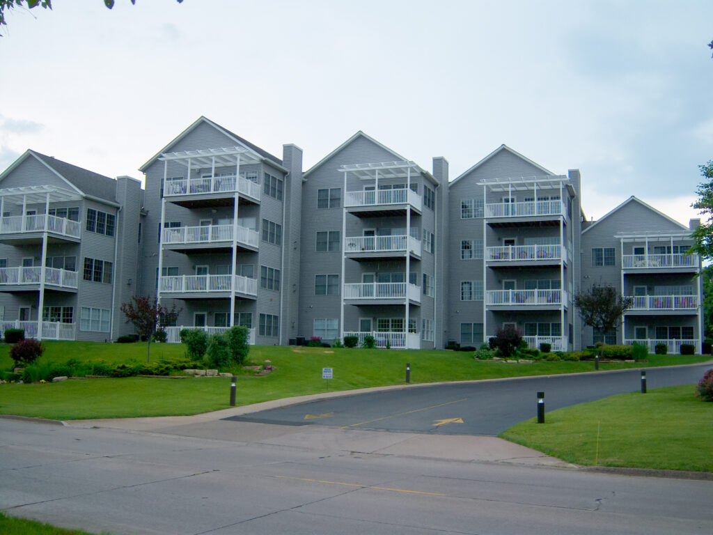 Exterior of a condo unit with pergolas over the top decks