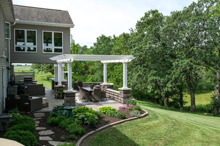 Freestanding pergola on nicely landscaped backyard
