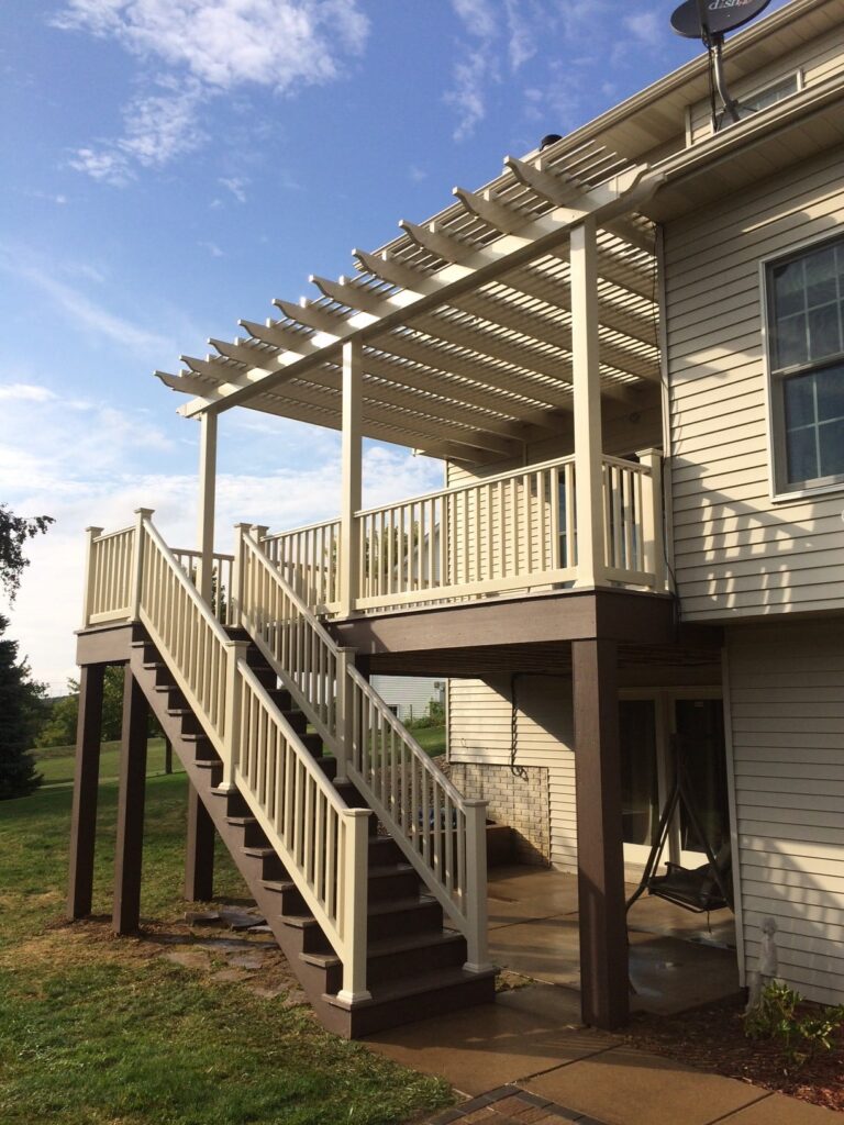 Raised deck with a tan attached pergola