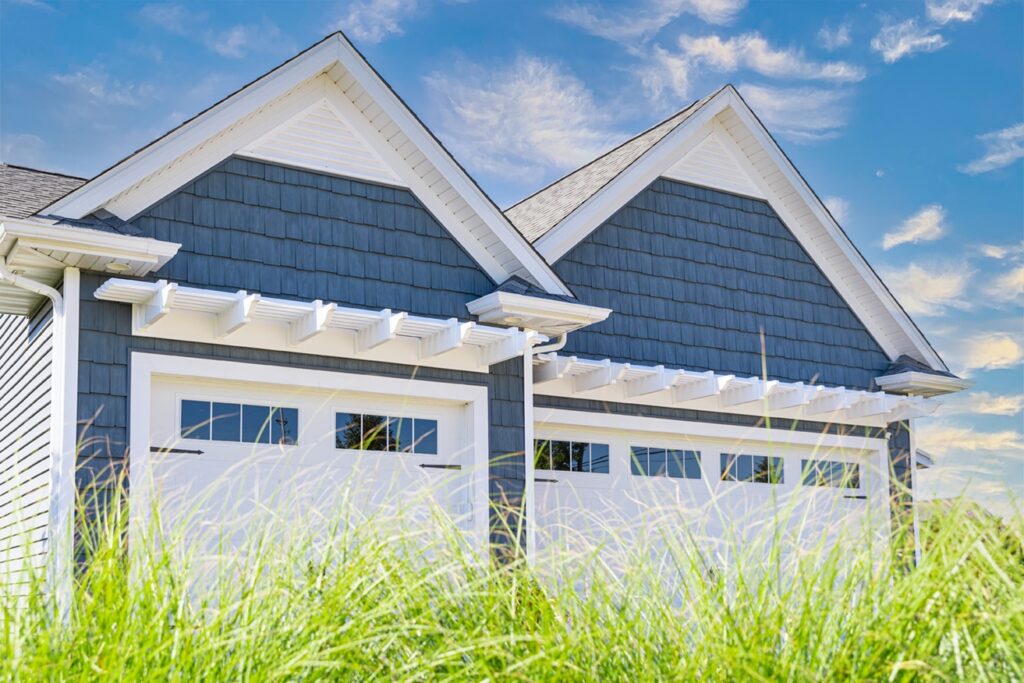 white eyebrow pergolas above three car garage