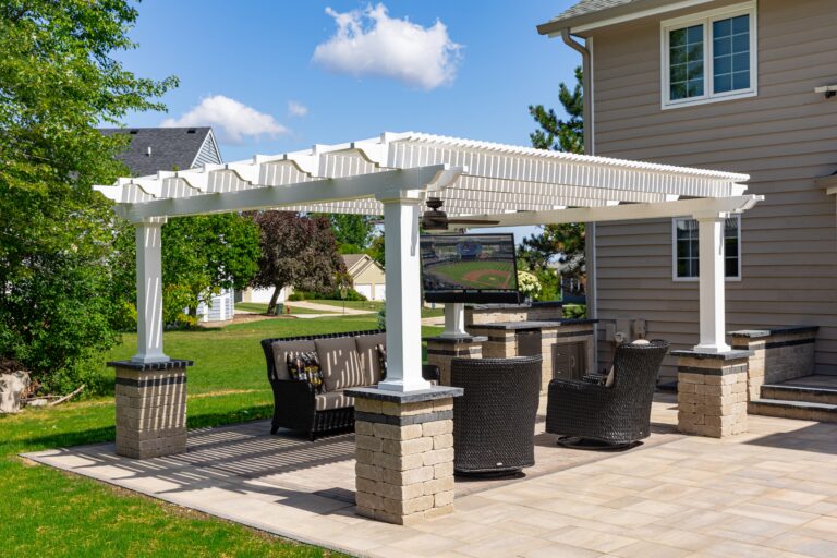 Freestanding pergola over outdoor seating and tv area with fire table