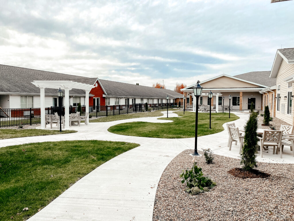 Liberty village senior living courtyard with shade pergolas along the walkway