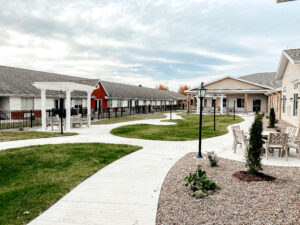 Liberty village senior living courtyard with shade pergolas along the walkway