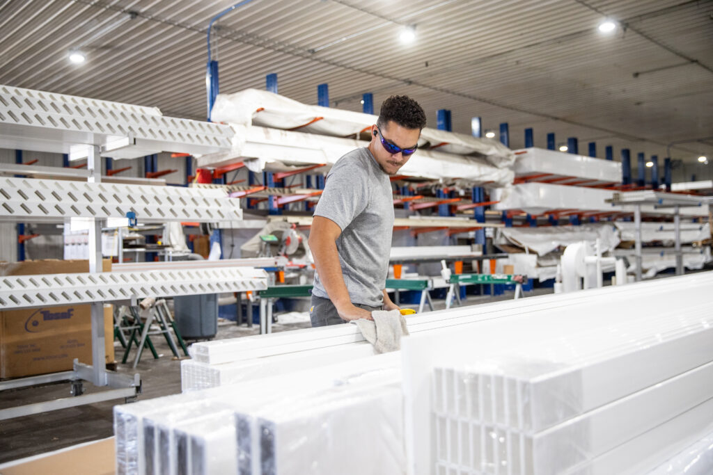 Heartland Pergola Shop Worker prepares vinyl pergola kits for shipping