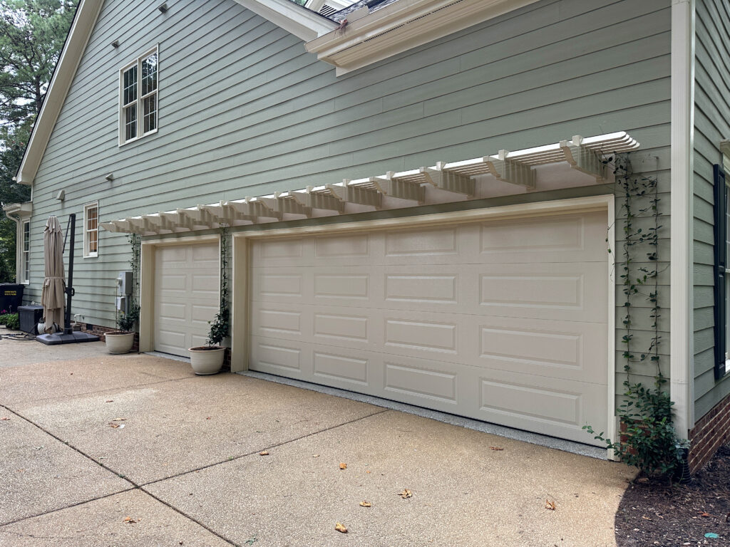 Custom eyebrow pergola over single garage door and double garage doors