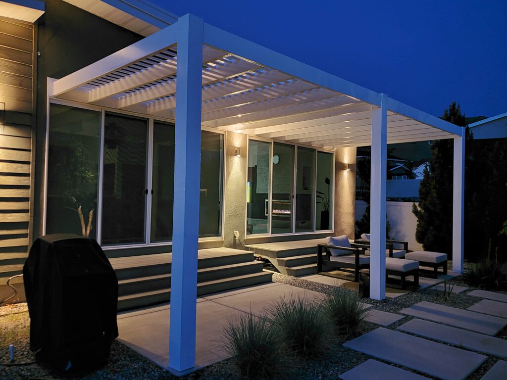 Night view of a modern pergola lit up over a patio