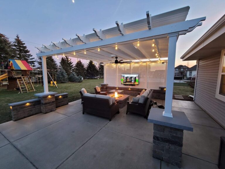 Outdoor pergola at dusk with tv and fan