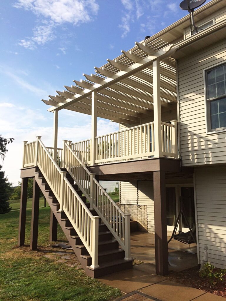 Tan attached shade pergola on a raised deck