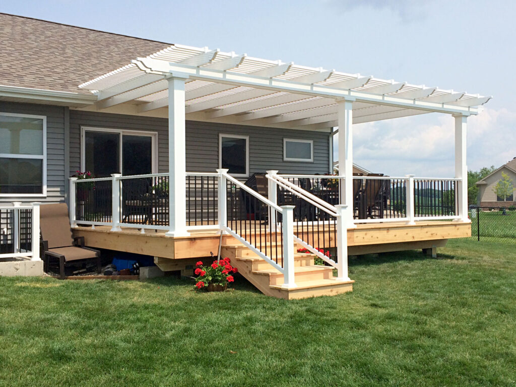 White vinyl attached pergola over a wood deck