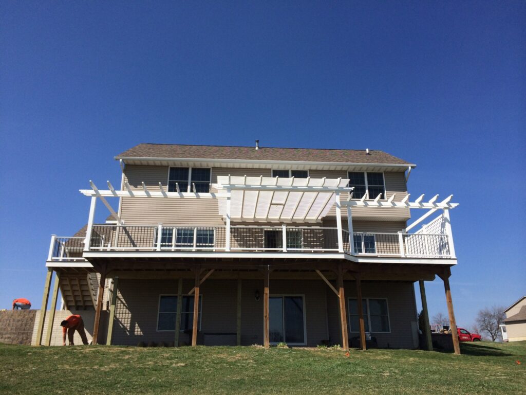 custom pergola with extending arbors on a raised deck