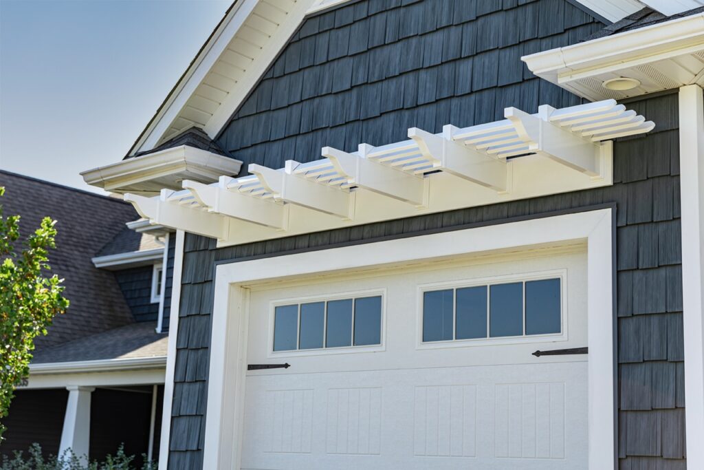 single garage door with white eyebrow pergola