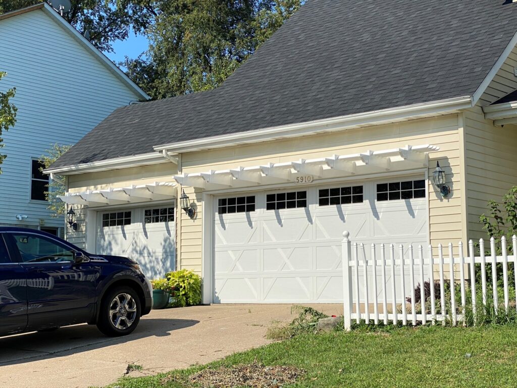White vinyl pergola over a three car garage