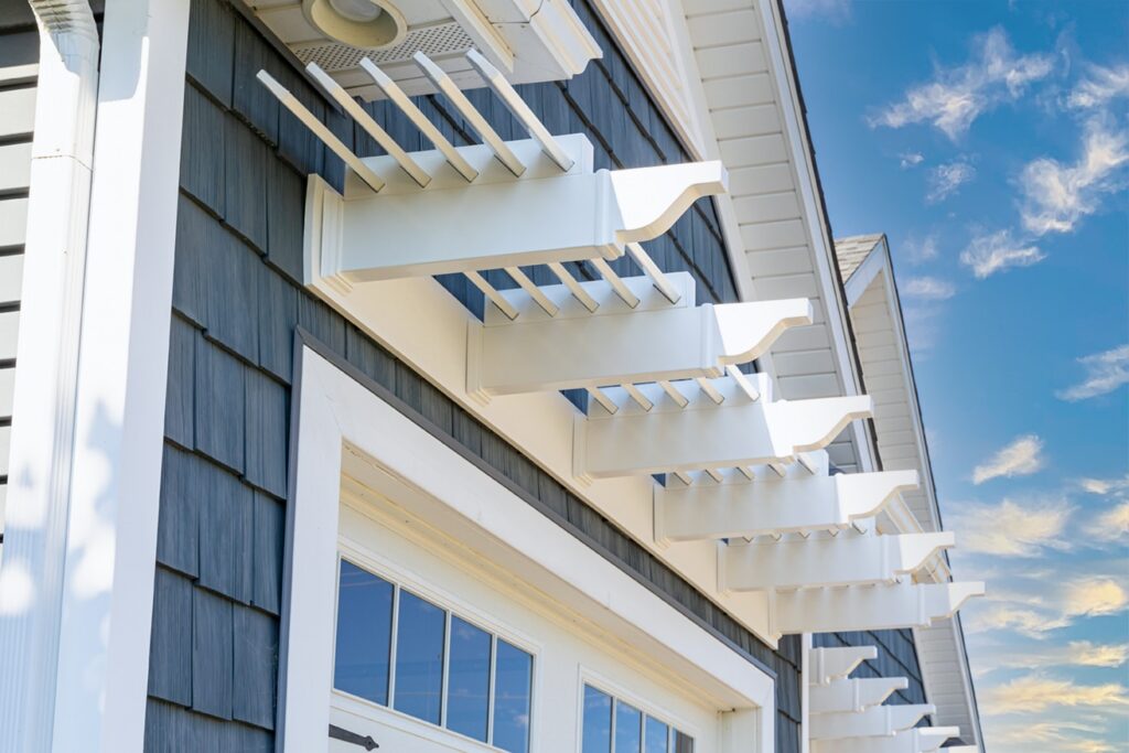 White eyebrow pergola above a single garage door