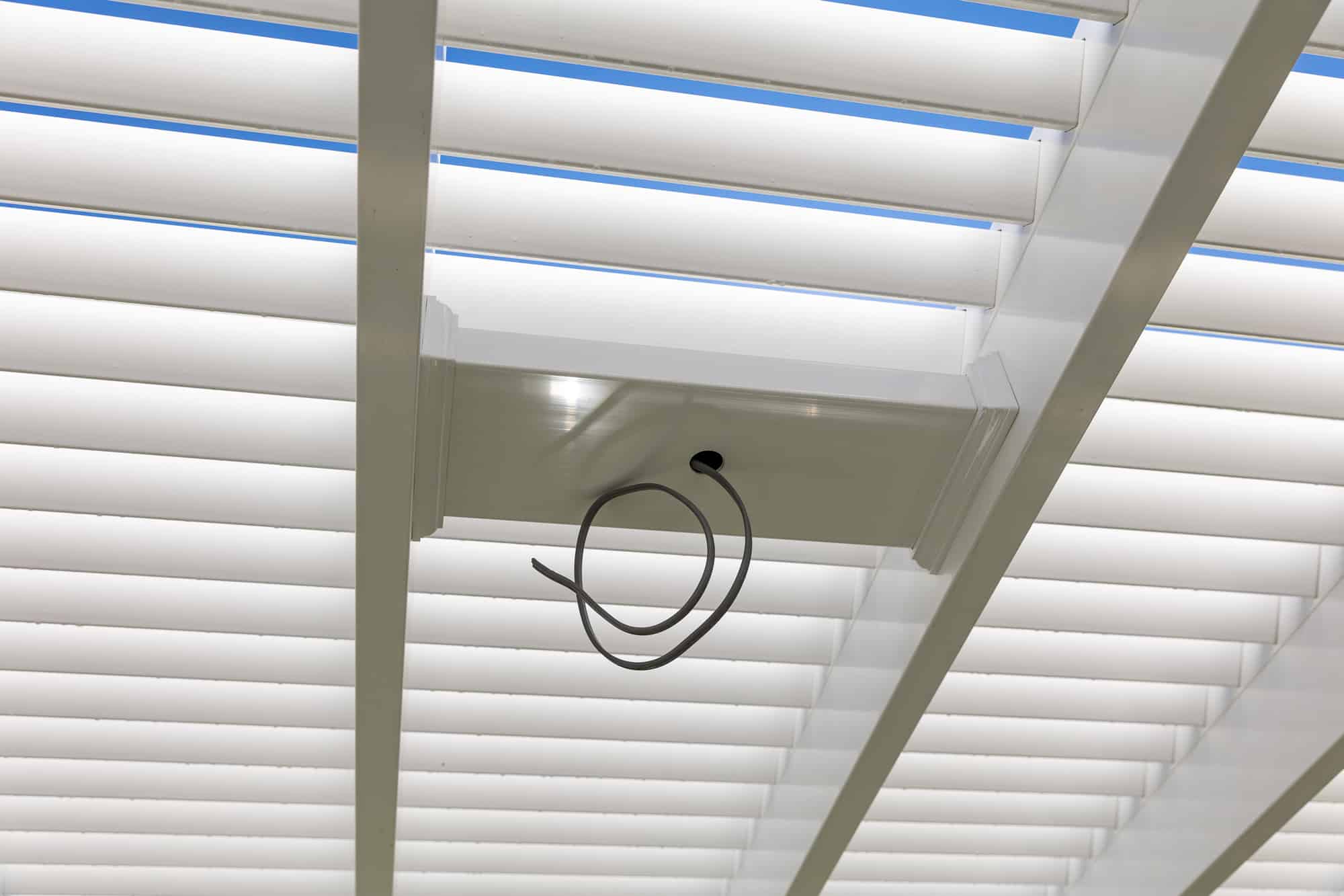 Fan mount close up as attached pergola with wires pulled through the center of the mount
