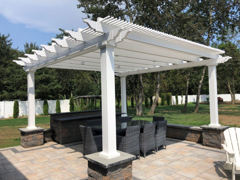 Freestanding shade pergola over a paver patio and dining area