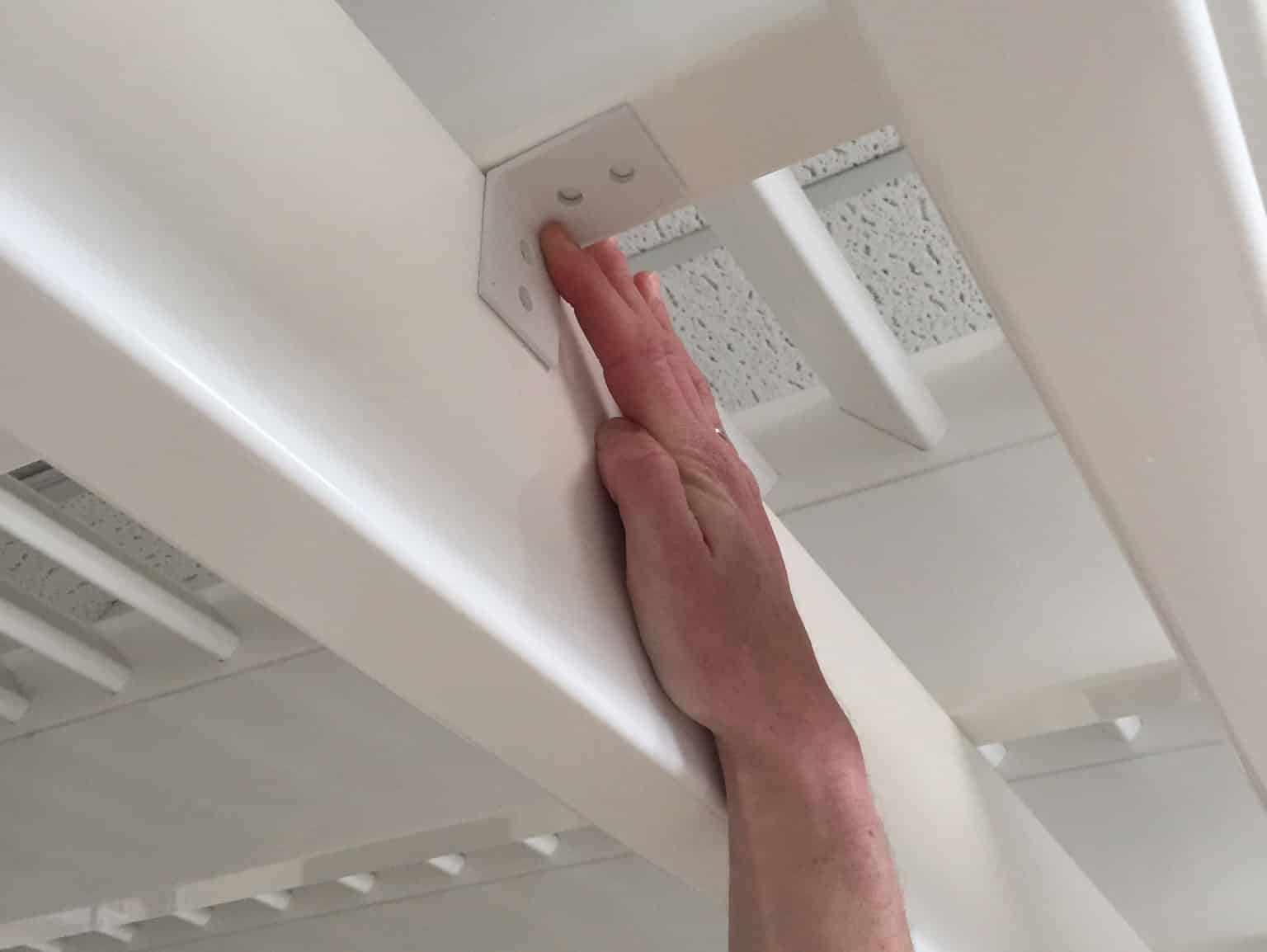 holding up a hurricane clip up under the pergola rafter