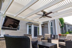 underside of outdoor pergola with fan and tv for patio seating