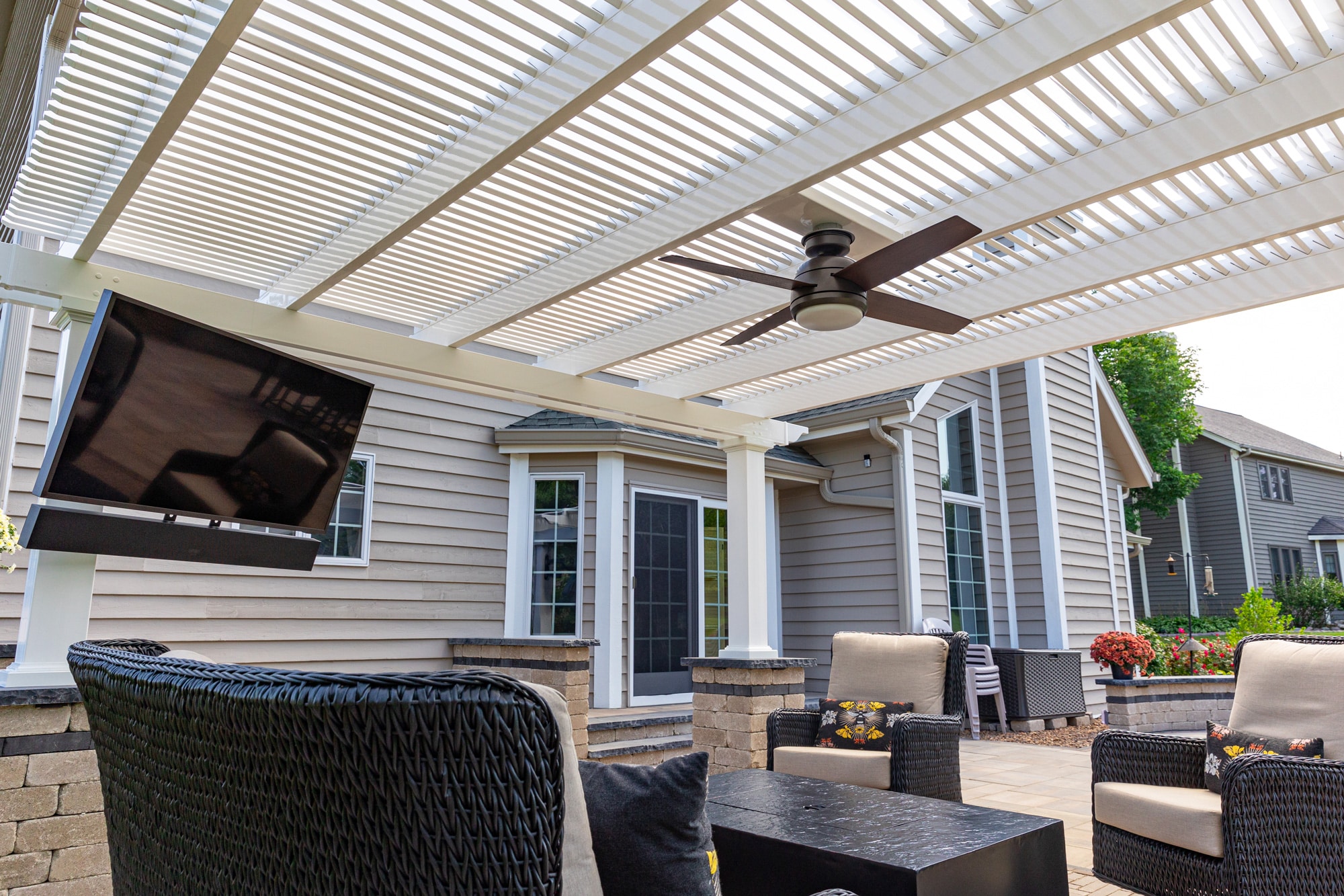 underside of outdoor pergola with fan and tv for patio seating