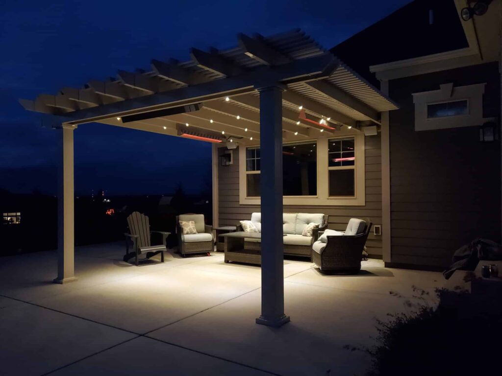 attached pergola at night fitted with outdoor heaters