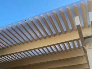 close up of pergola roof purlins with a clear polycarbonate sheet over top