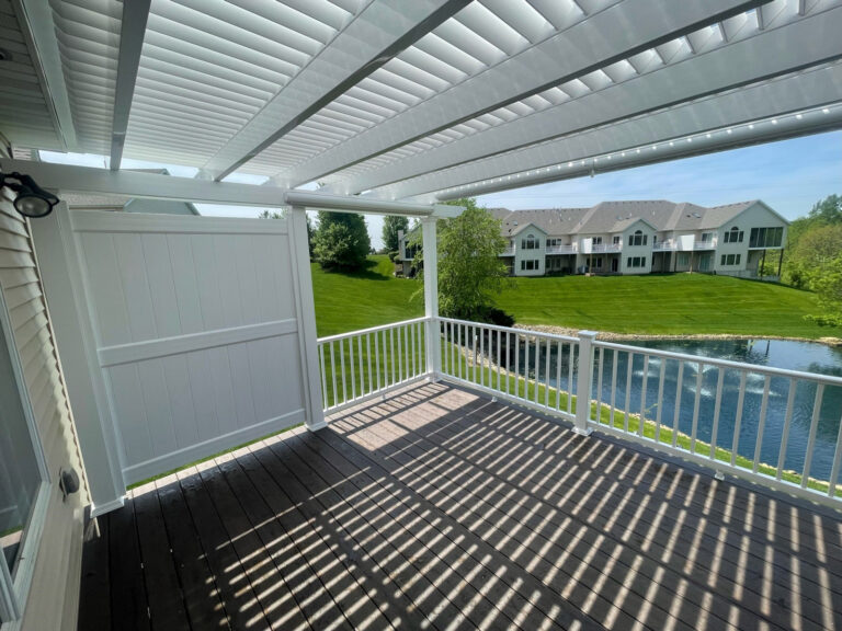 pergola over a deck with side vinyl privacy wall attached to the pergola.