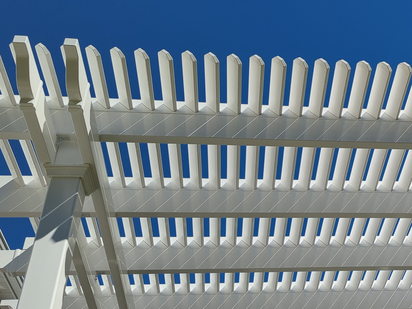 Looking up at the shade purlins of a shade pergola