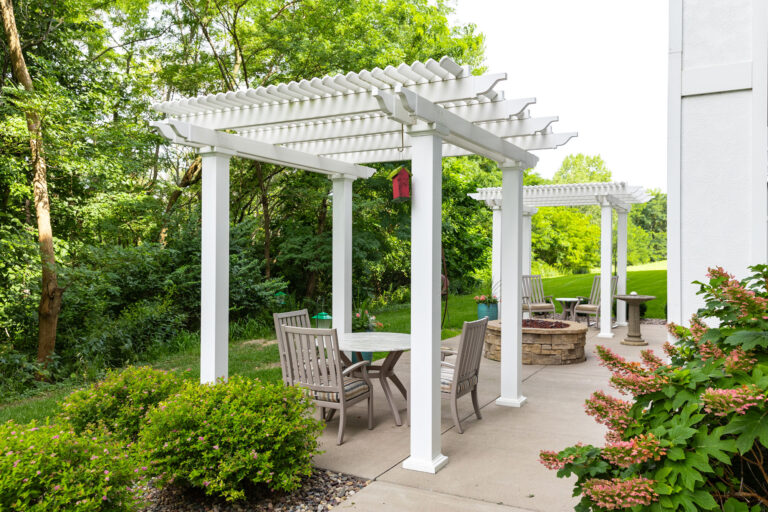 outdoor patio of senior living apartments featuring two shade pergolas for residents enjoyment
