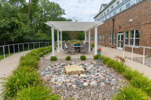 Side view of a large shade pergola over an assisted living patio