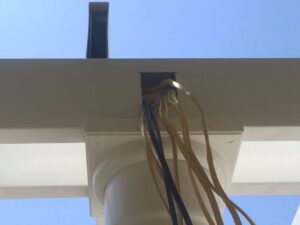 Electrical wiring pulled through the post and beams of a pergola